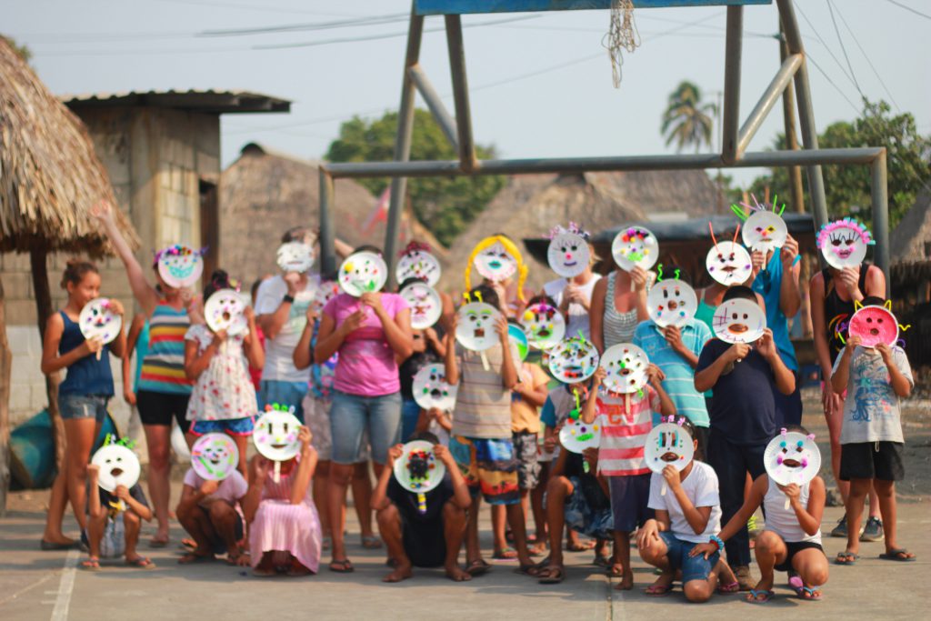 Children posing with masks